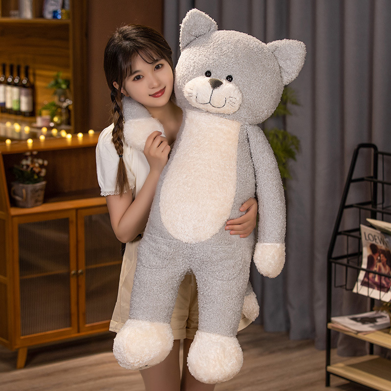 Gray jimmy cat plush toy displayed in a warm indoor setting, featuring fluffy texture, gentle facial details, and full-body softness for hugging, relaxing, and bedroom decoration
