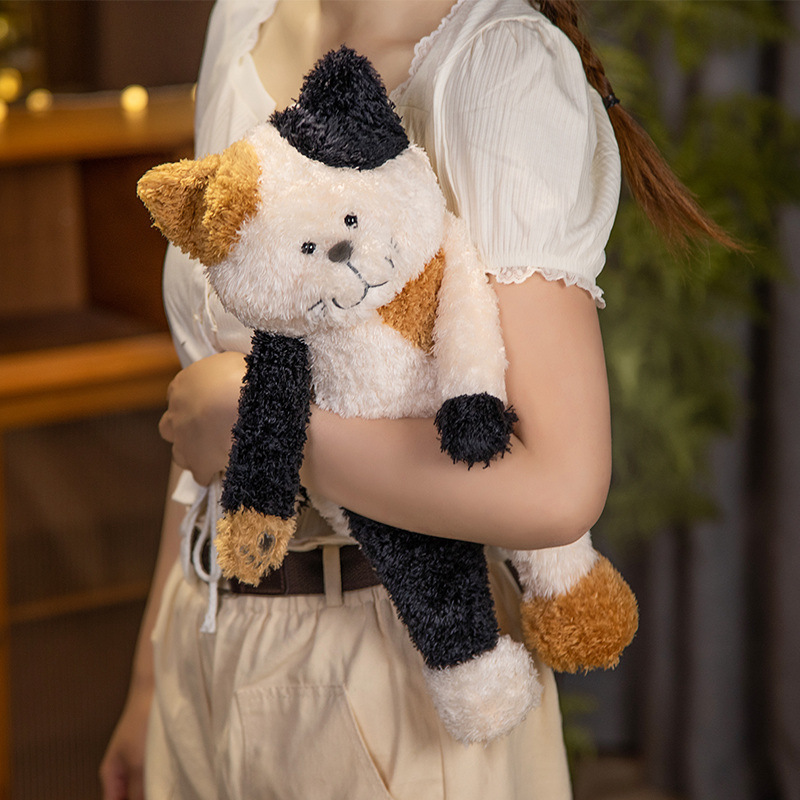 Calico jimmy cat plush toy with soft textured fabric, shown being hugged comfortably, highlighting compact size, gentle stitching details, and cozy feel, suitable for daily cuddling, relaxation, or decorative display in a warm indoor setting