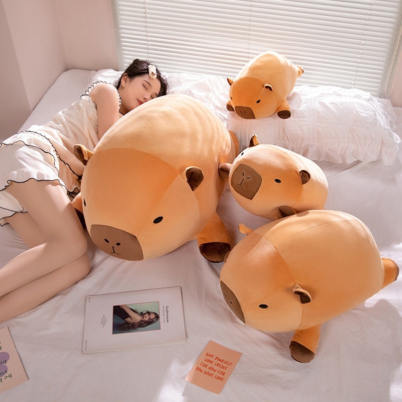 Lying capybara plush pillow on a bed, soft and oversized body pillow creating a cozy and relaxing bedroom atmosphere