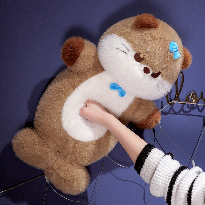 Sea otter plush toy being gently squeezed to show soft plush fabric, elastic filling, and squishy, comforting texture