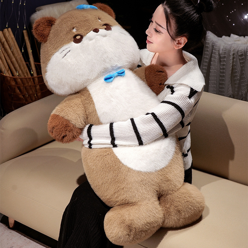 Sea otter plush toy held in a cozy indoor setting, showing soft plush texture and supportive shape, ideal for hugging, relaxing, and bedtime comfort