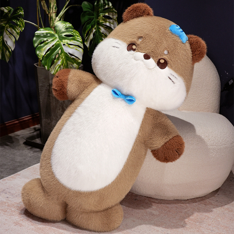 Sea otter plush toy leaning against a soft chair in a cozy indoor setting, showing plush texture, rounded shape, and comfortable hugging use