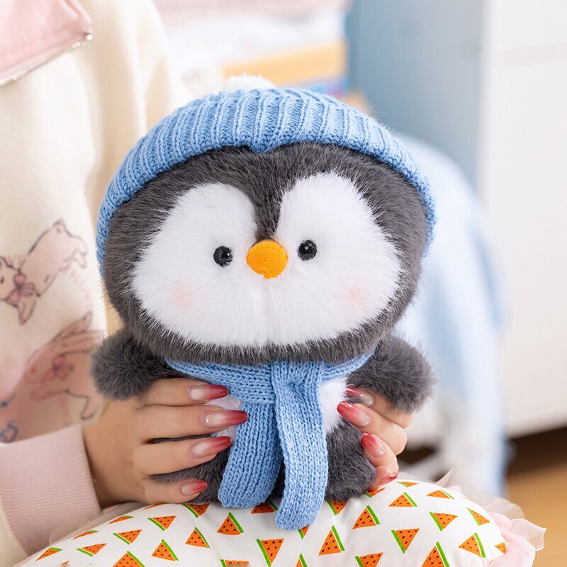 Coco standing penguin plush toy wearing a blue knit hat and scarf, plush and huggable design ideal for relaxing, decorating sofas, or gifting