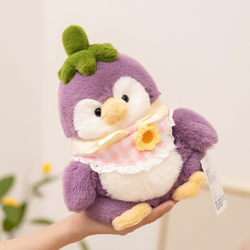 Eggplant penguin plush toy displayed at an angle, soft purple plush with green stem detail, cute stuffed animal for cozy decor and gifting