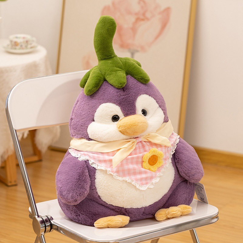 Eggplant penguin plush toy sitting on a chair, soft purple plush with green stem detail, cozy home decor accent with a cute and calm atmosphere