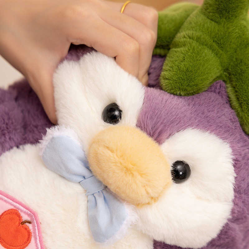 Eggplant penguin plush toy pressed to show soft texture and fluffy PP cotton filling for cozy hugging