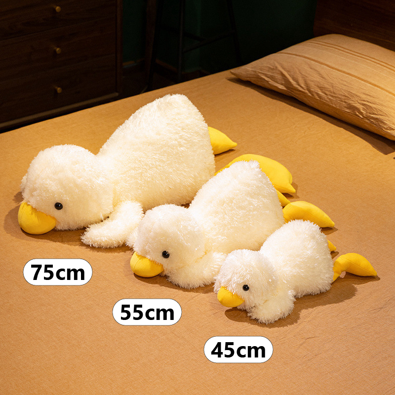 Lying white duck plush pillow size comparison showing 45 cm, 55 cm, and 75 cm options arranged on a bed for easy size reference