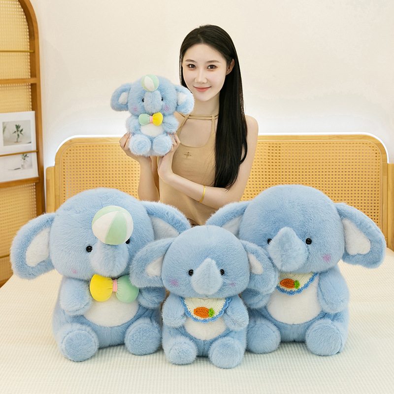 Happy elephant plush toy in multiple sizes displayed on a bed, highlighting soft texture, cute details, and a cozy home atmosphere