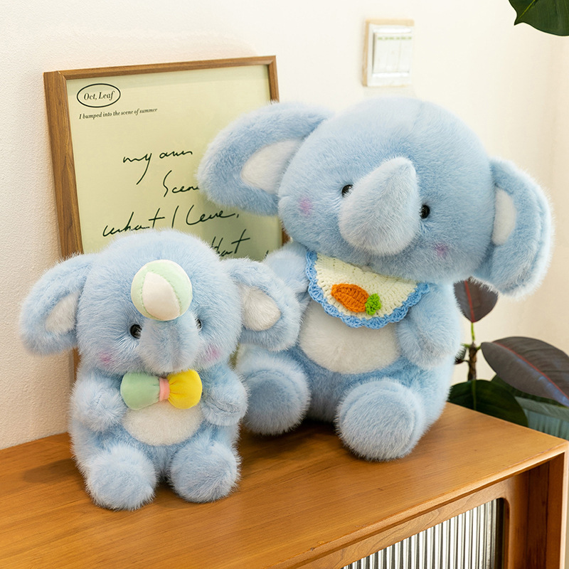 Happy elephant plush toys in multiple sizes placed on a wooden cabinet, showing soft stuffed elephant designs ideal for hugging, gifting, and adding a cozy touch to home decor