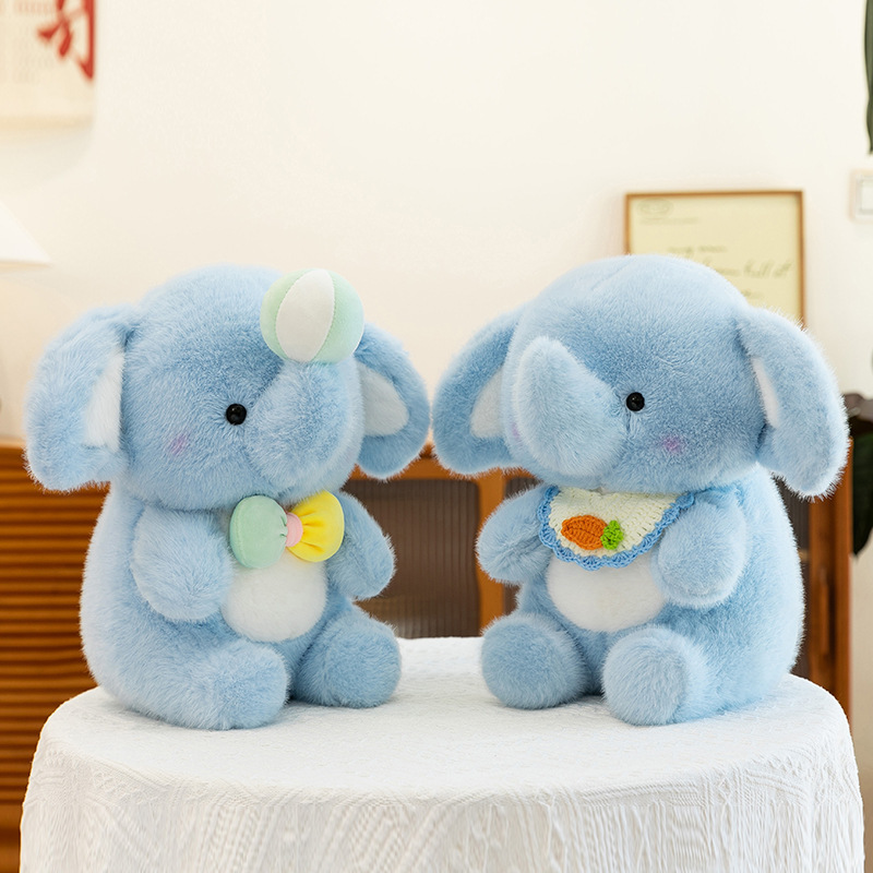 Happy elephant plush toys in bib and bow variants displayed side by side, featuring soft plush texture, rounded shape, and cute design for home decor and gifting