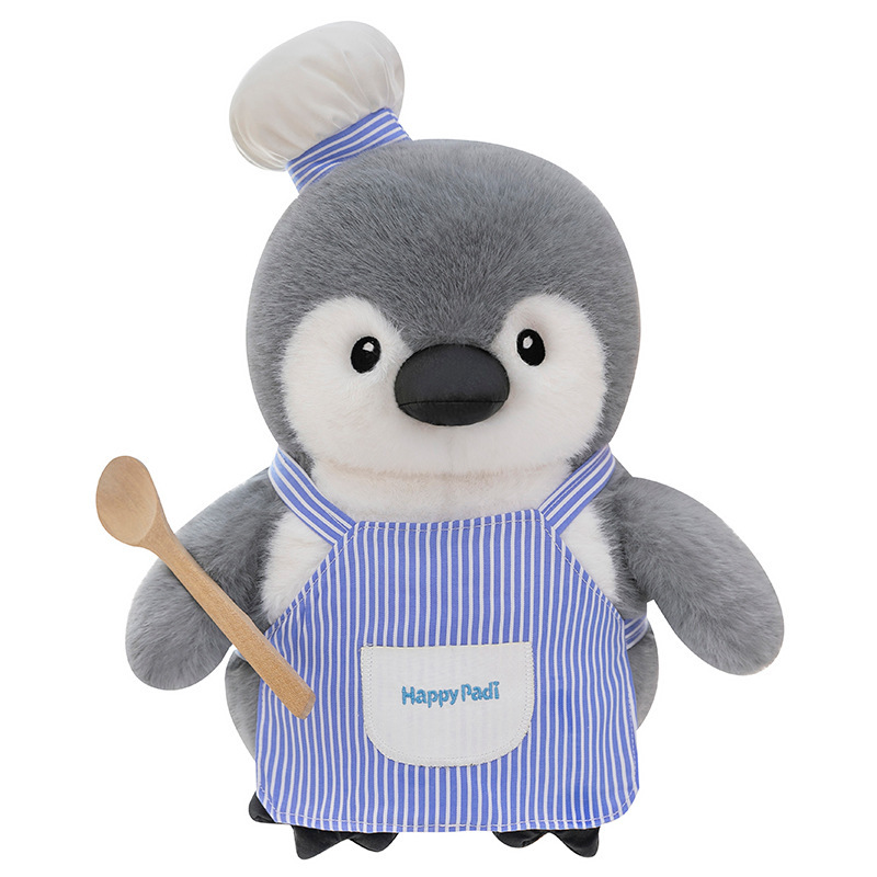 Chef penguin plush toy with striped apron and chef hat, soft plush fabric and rounded body, shown on white background