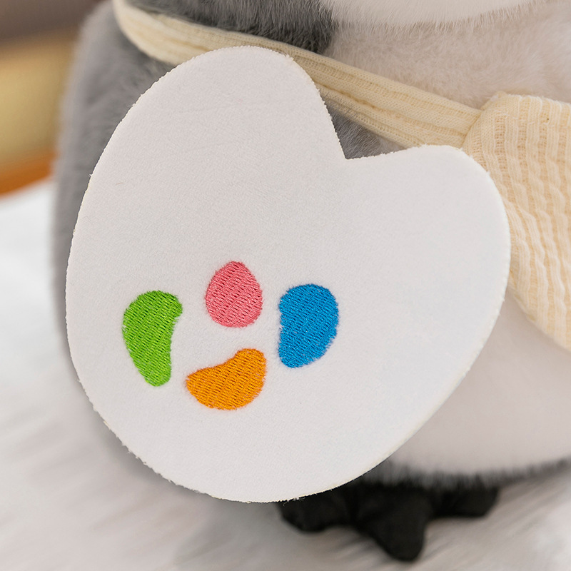 Painter penguin plush toy heart-shaped palette accessory with embroidered colors, soft plush detail for cute home decor or gifting