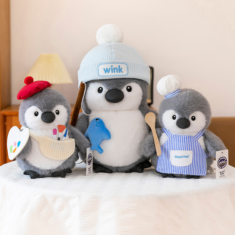 Chubby penguin plush toys in chef, fishing and painter designs displayed together on a table, highlighting soft plush texture, rounded shape and cozy home decor feel