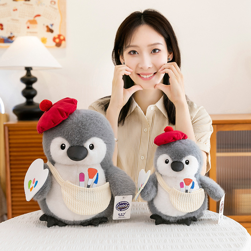 Painter penguin plush toys in two sizes displayed side by side, chubby soft design with beret and paintbrush details, ideal for gifting, cuddling, and cozy home decor