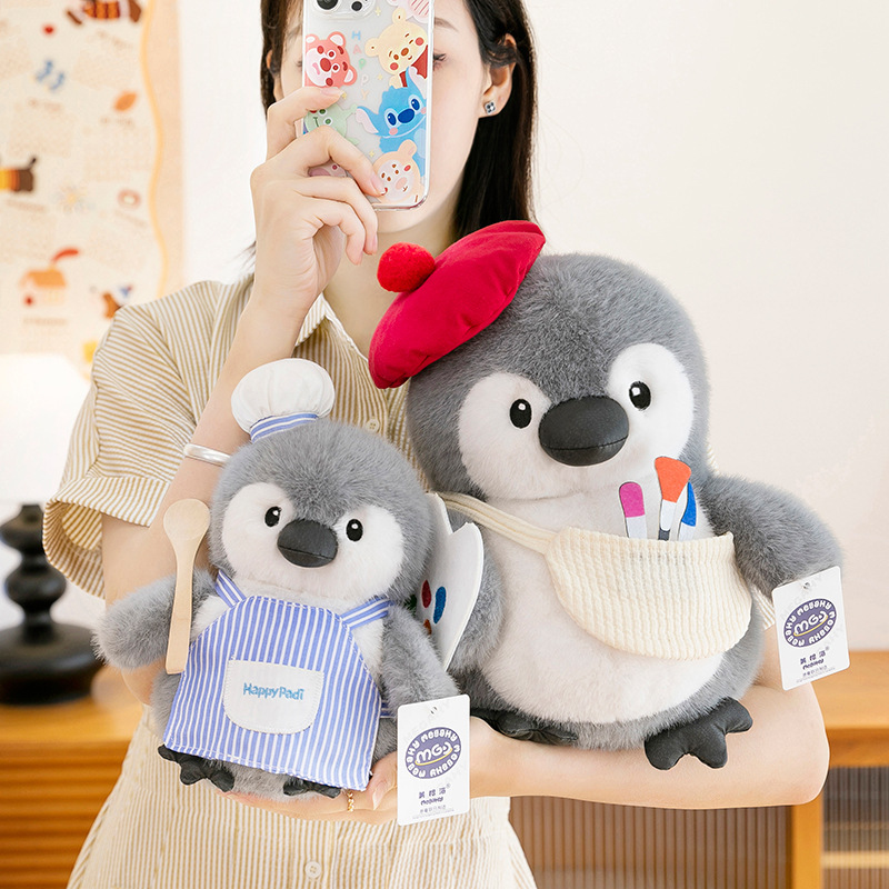 Chubby penguin plush toys in chef and painter designs shown in two sizes, highlighting size difference, rounded shape and soft plush texture for hugging
