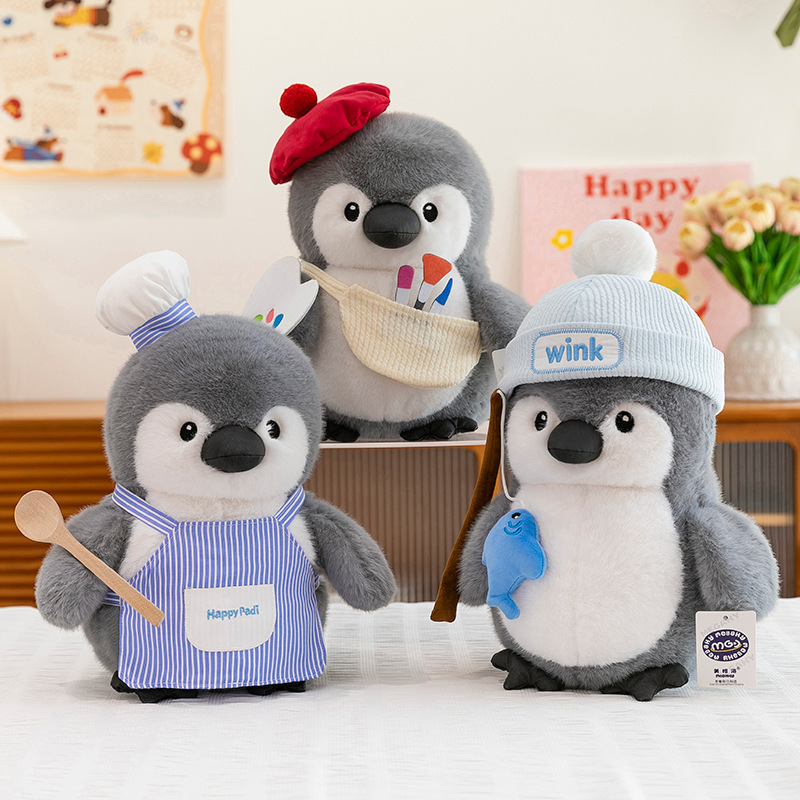 Chubby penguin plush toys in chef, painter and fishing styles displayed on a table, highlighting cozy home decor use and playful atmosphere