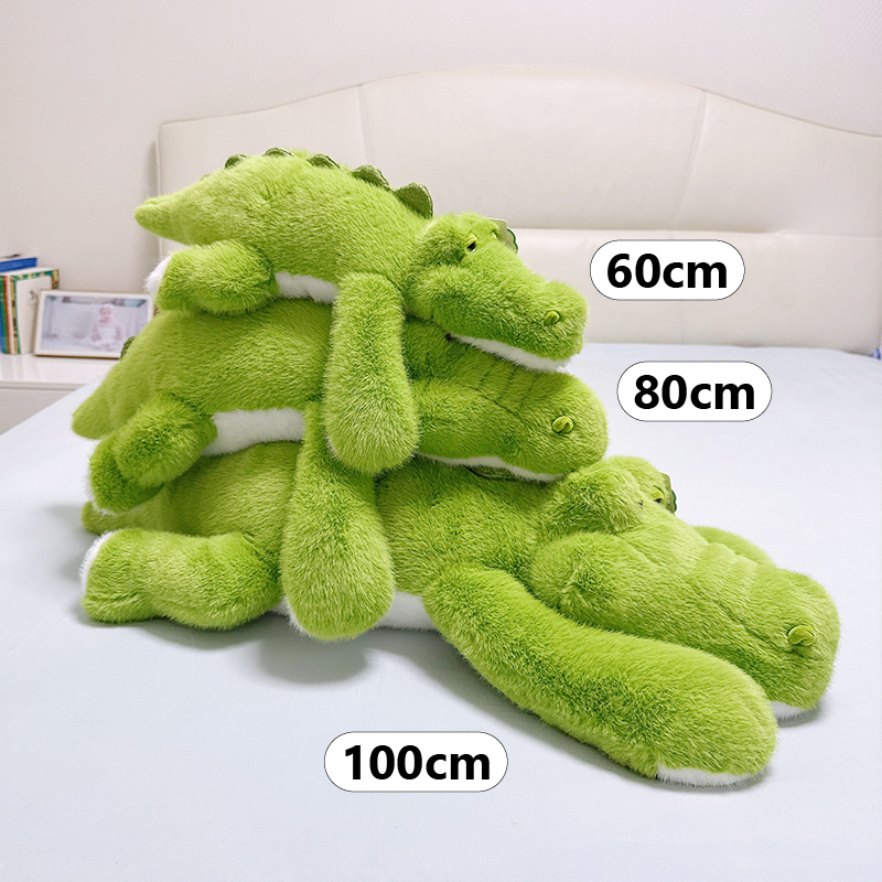 Lying crocodile plush toy size comparison 60cm 80cm and 100cm on bed