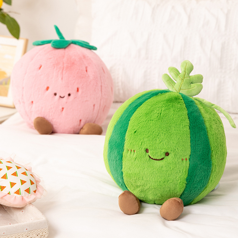 Cute fruit plush pillows in watermelon and strawberry designs displayed on bed