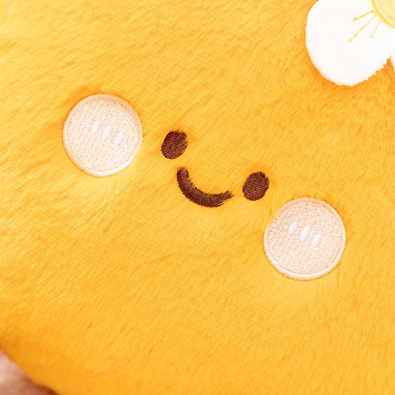 Orange fruit plush pillow close up showing embroidered face and soft plush texture