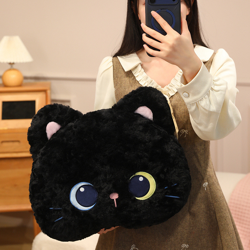 Black cat head plush pillow with soft textured plush fabric and embroidered eyes, cute kitty face cushion for sofa, bed, and relaxing spaces