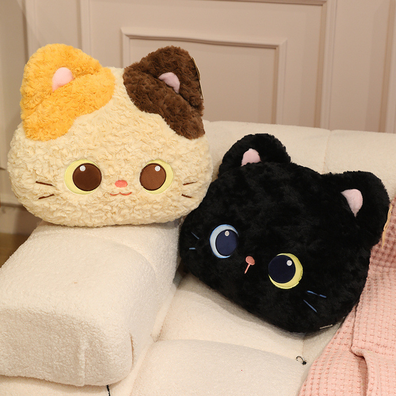 Calico and black cat head plush pillows displayed on a sofa with a soft blanket, featuring plush fabric and cute kitty face details, perfect for home decor, lounging, and cozy relaxation