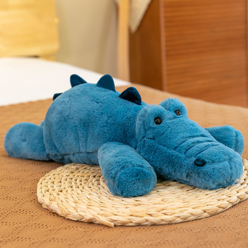 Blue crocodile lazy lying plush toy with soft fluffy fabric, displayed on woven mat, cozy cuddly animal pillow for sofa or bed decor