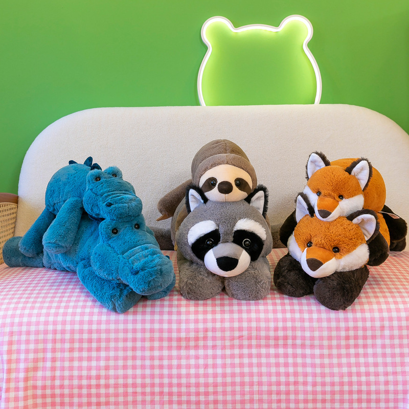 Aurora lazy lying animal plush toys featuring crocodile, raccoon, fox and sloth displayed on a sofa with warm indoor decor, soft plush companions for cuddling and relaxation