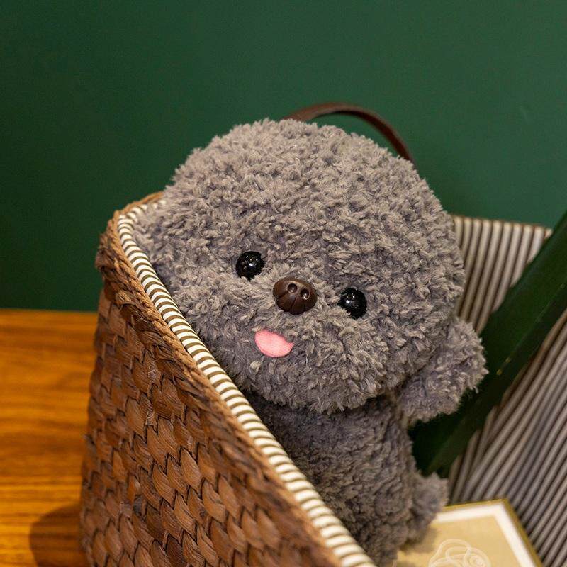 Gray Bichon Frise plush toy sitting inside a woven basket, highlighting fluffy teddy plush fabric, playful tongue detail, and decorative home styling