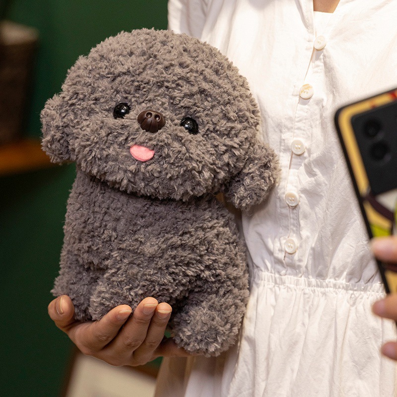 Gray Bichon Frise plush toy held in hand showing compact 20cm size, fluffy teddy plush texture, tongue-out expression and soft stuffed dog design for cuddling or display