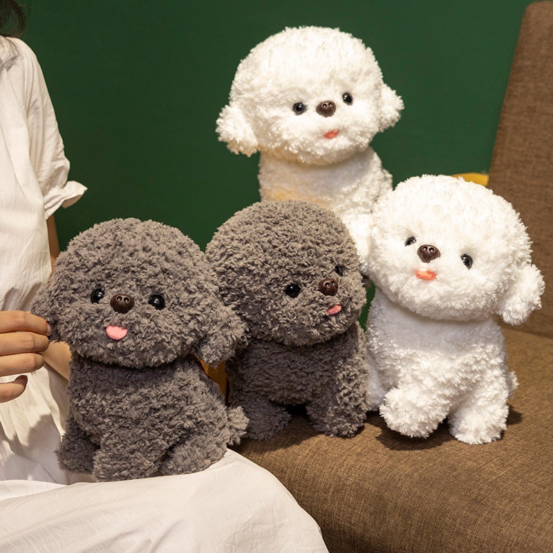 Gray and white Bichon Frise plush toys arranged on a sofa, showcasing soft texture, cute tongue-out expression, and charming home decor display