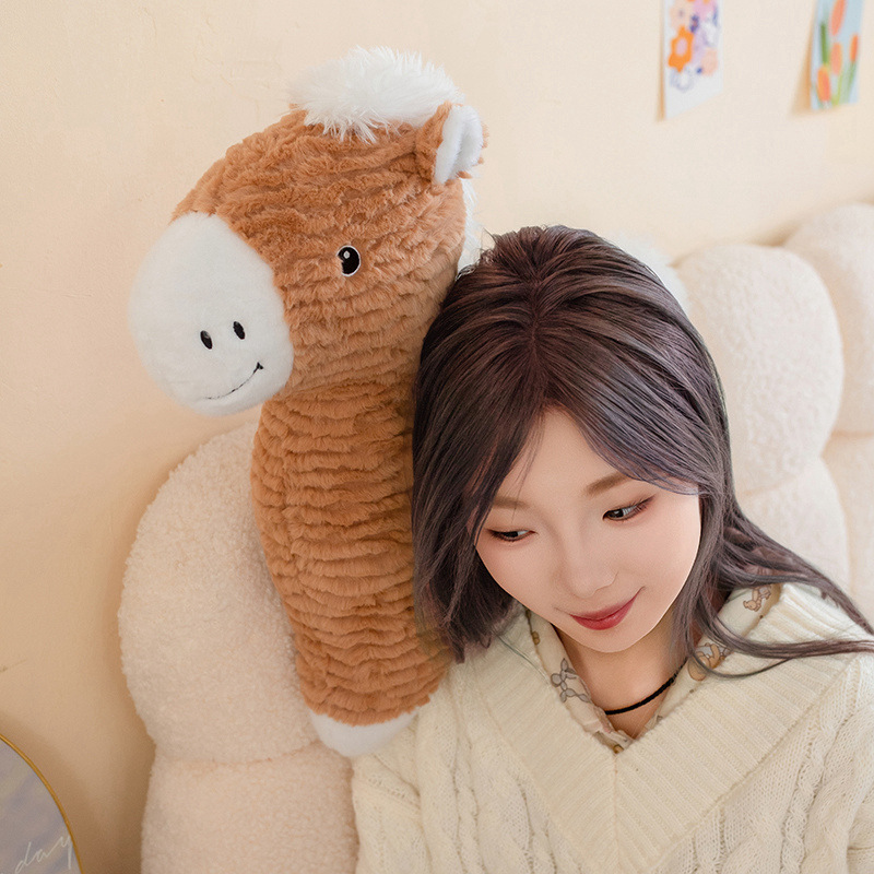 Brown horse plush pillow held in a cozy bedroom setting, featuring soft textured plush fabric, fluffy white mane, and comforting hugging size for relaxing or napping
