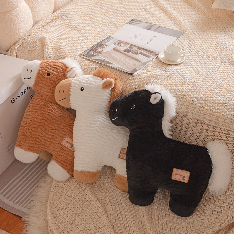 Horse plush pillows in white, brown, and black arranged on a cozy bed, fluffy animal cushions for relaxing and home decor