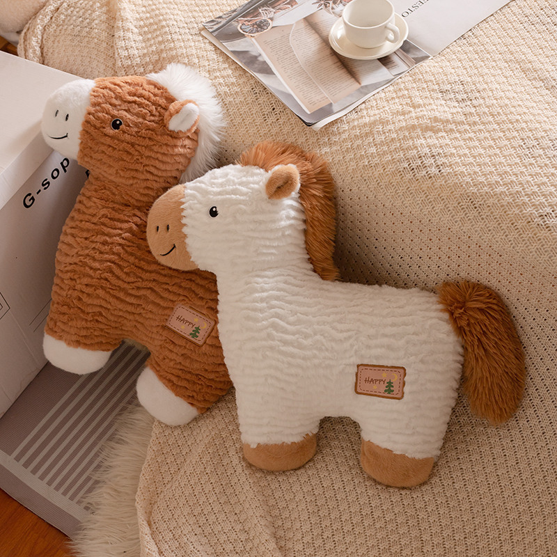 White and brown horse plush pillows placed on a cozy bed, soft animal cushions with textured fabric for home decor and relaxation