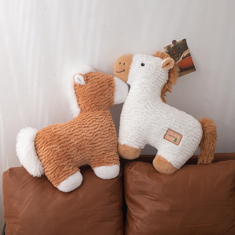 White and brown horse plush pillows displayed on a sofa, soft textured animal cushions for cozy home decor
