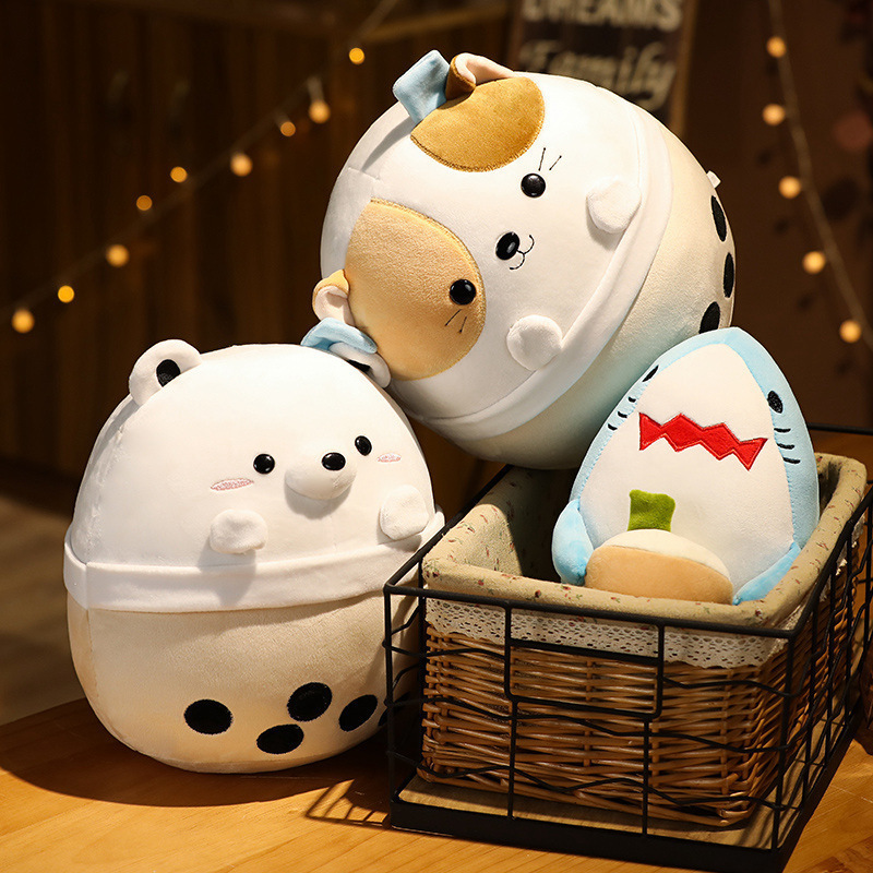Milk tea animal plush toys in bear, cat and shark designs arranged in a woven basket and on a table, soft plush texture with bubble tea cup details in a warm indoor setting