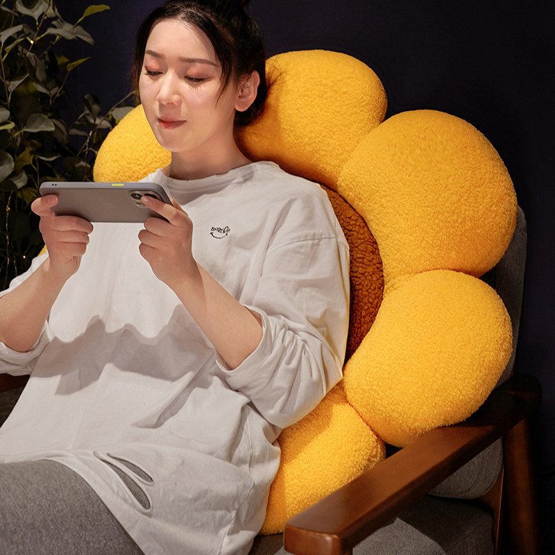 Sunflower plush cushion as soft backrest pillow on armchair, thick padded petals and plush fabric for relaxing, lounging and warm home comfort