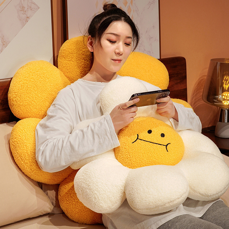 Sunflower plush cushion used as a soft back support and hug pillow, thick padded petals for cozy seating and lounging