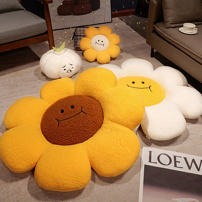 Sunflower plush cushions in different color combinations placed on the floor in a cozy living room setting, soft round flower seat pillows with thick padded petals