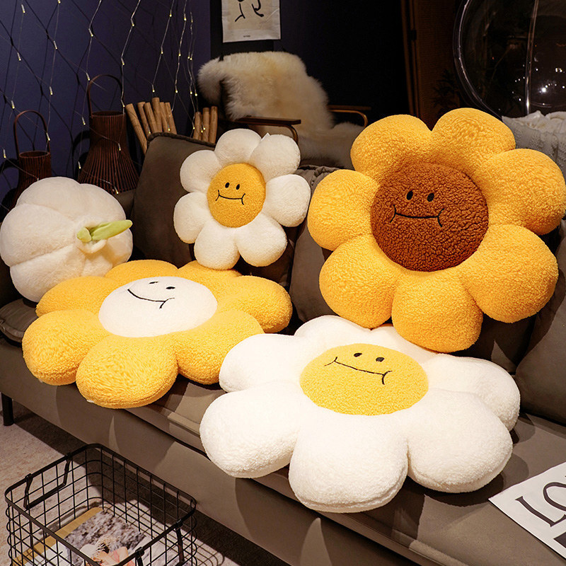 Sunflower plush cushions in white, yellow and brown center designs displayed on sofa and floor, soft petal shape ideal for seating, lounging and cozy home decor