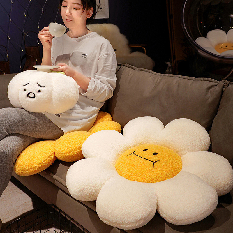 Sunflower plush cushion on sofa with soft fluffy petals and smiling face design, cozy decorative seat pillow for relaxing and warm home decor