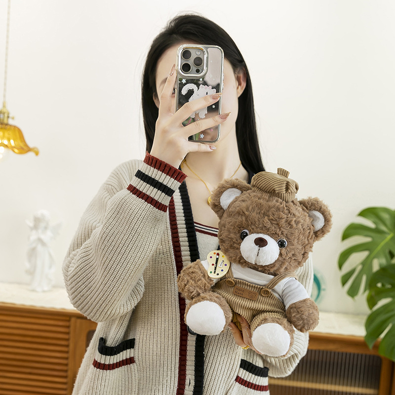 Mocha bear plush toy in brown outfit displayed in hand, compact 28cm size suitable for hugging and decor