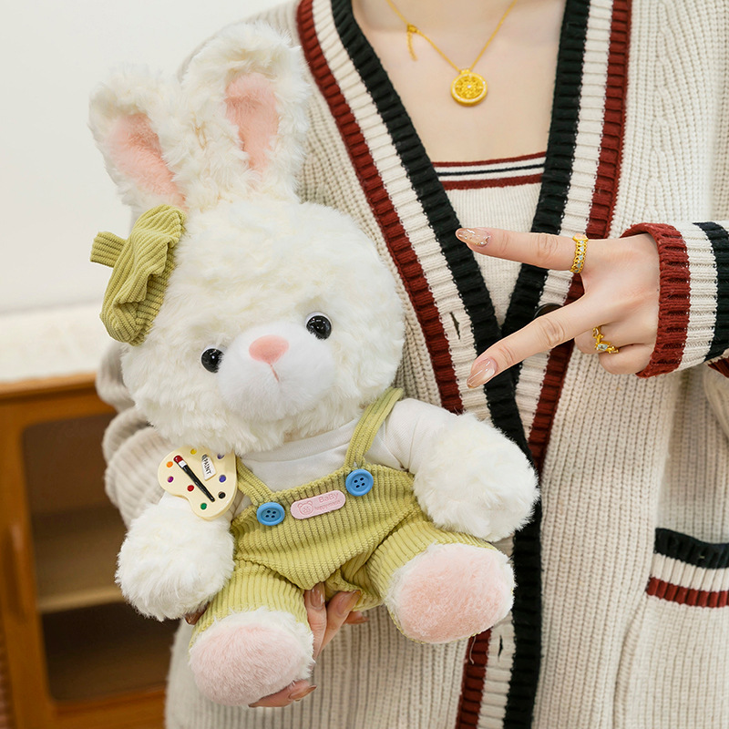 Mora bunny plush toy in pastel outfit displayed in hand, soft stuffed animal ideal for hugging and decor