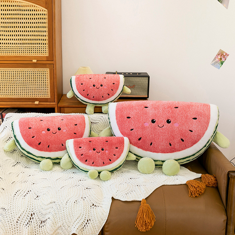 Watermelon plush pillows in multiple sizes arranged together on sofa in cozy home setting