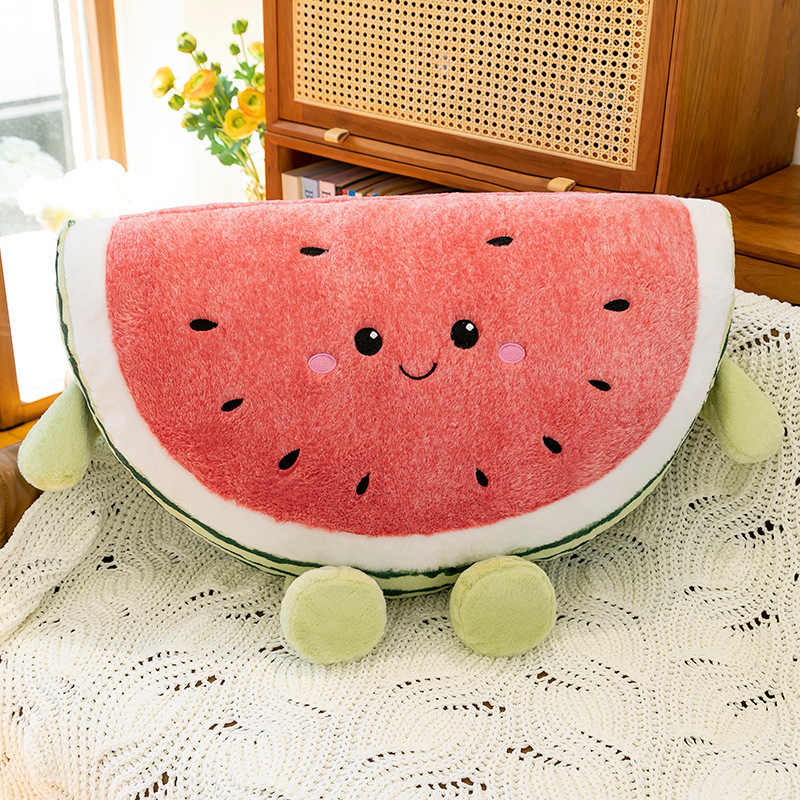 Watermelon plush pillow placed on knitted blanket in cozy living room setting