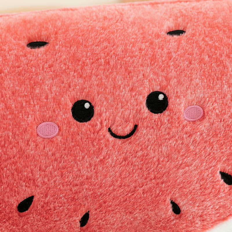 Close up of watermelon plush pillow face with embroidered details