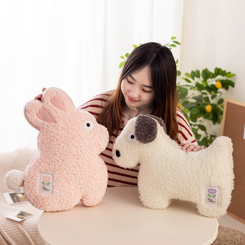 Maggie animal plush pillows in rabbit and dog designs displayed on a round table, highlighting fluffy texture and cute decorative cushion style