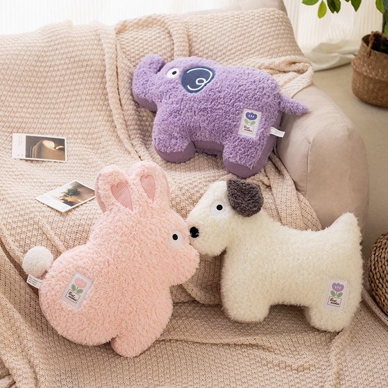 Maggie animal plush pillows in rabbit, elephant and dog designs displayed on a sofa, styled as cozy decorative cushions for home decor