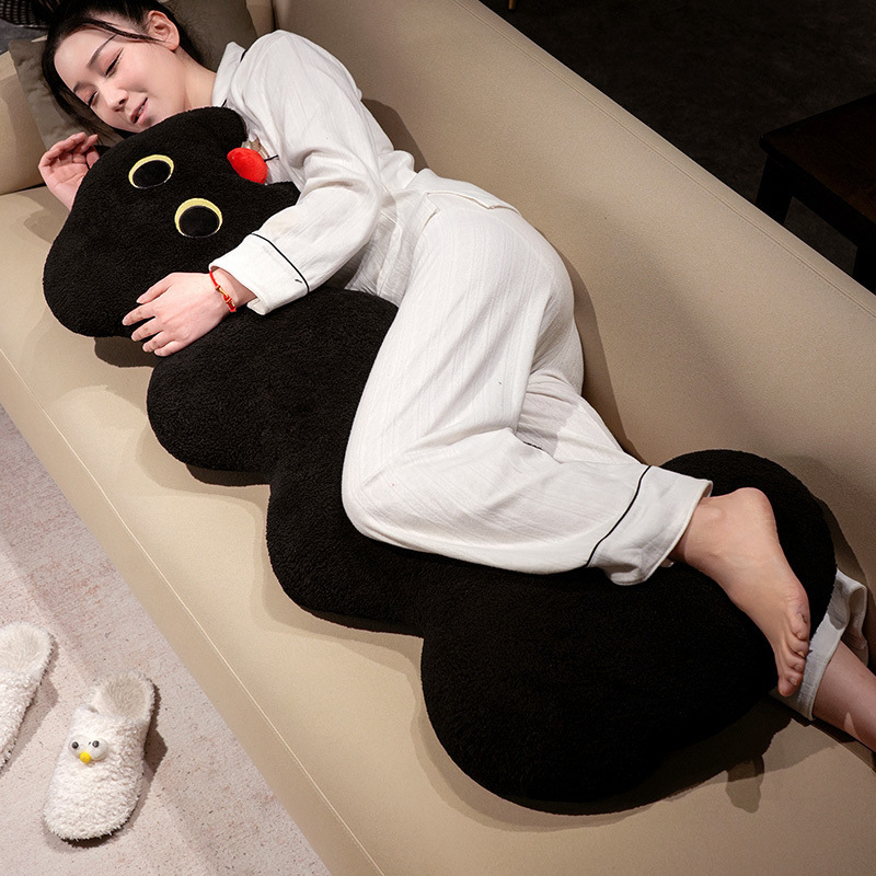 Cloud cat long plush pillow in black, soft elongated body cushion used for side sleeping and lounging on a sofa for comfortable full body support