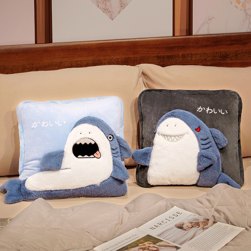 Shark plush pillow blankets displayed on a bed, showcasing the cozy cushion design and decorative bedroom use