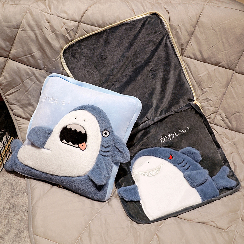 Shark plush pillow blanket partially unzipped to reveal the soft inner blanket, showing the 2-in-1 convertible cushion design for sofa and bedroom use
